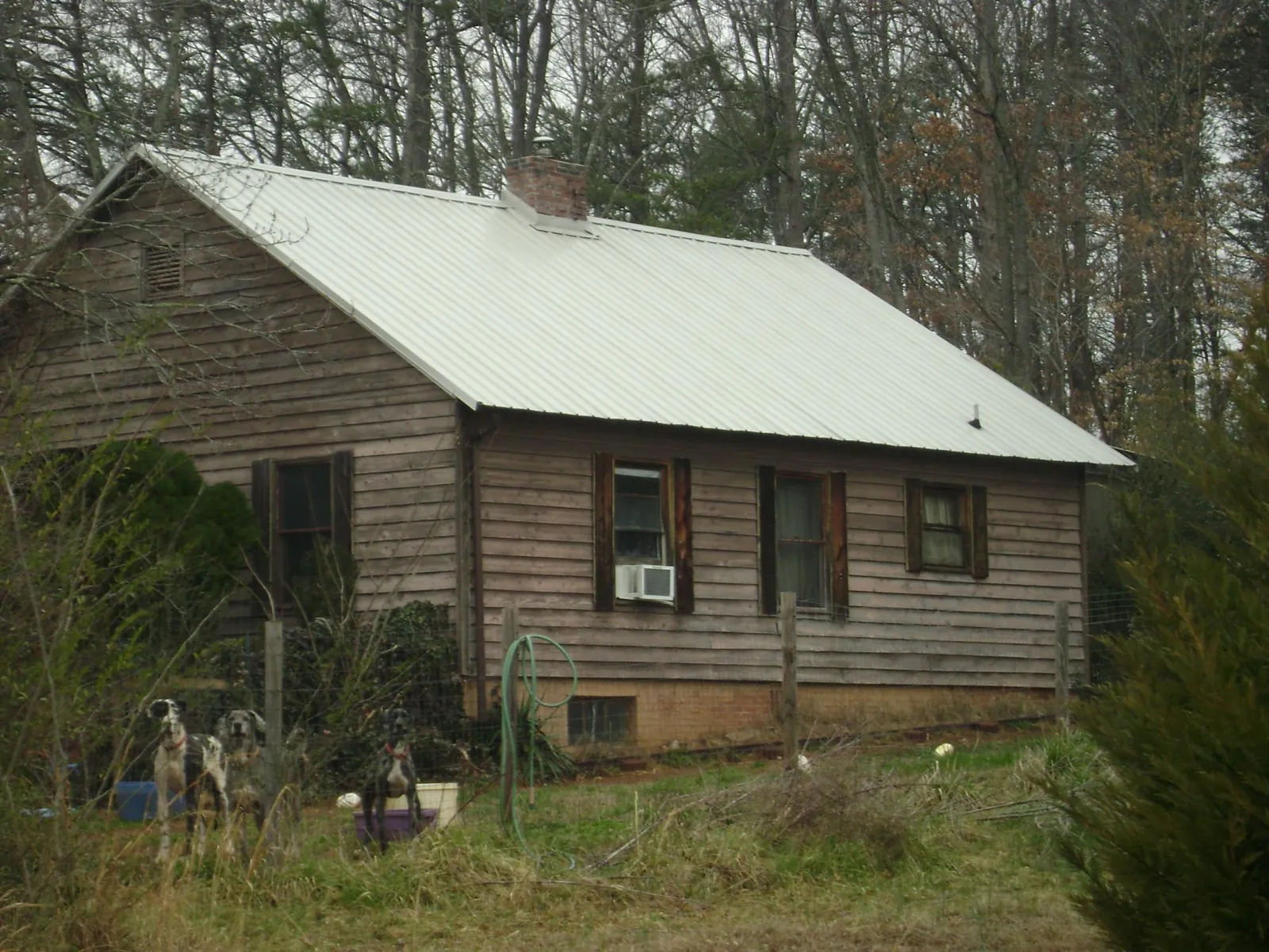 White metal roof on an old wood sided farmhouse, from a Metal Roof Installation job in New Boston